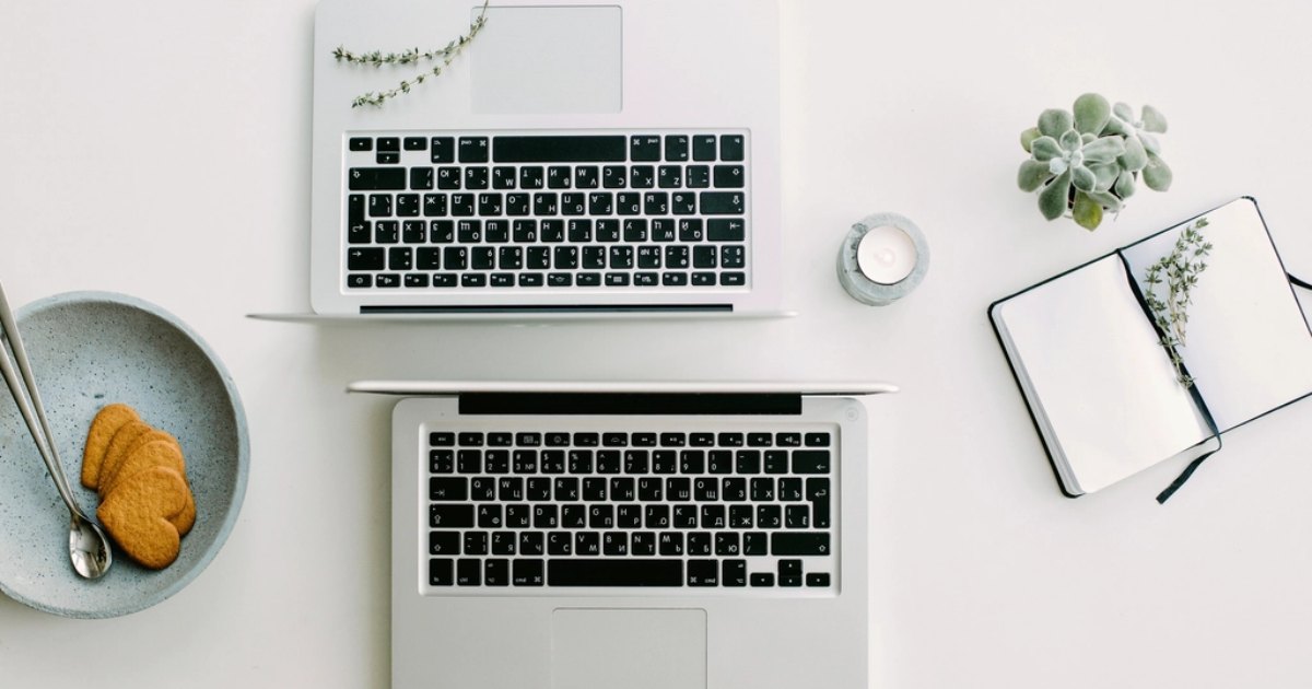 Laptop and open notebook on a desk, checking whether a business name is available